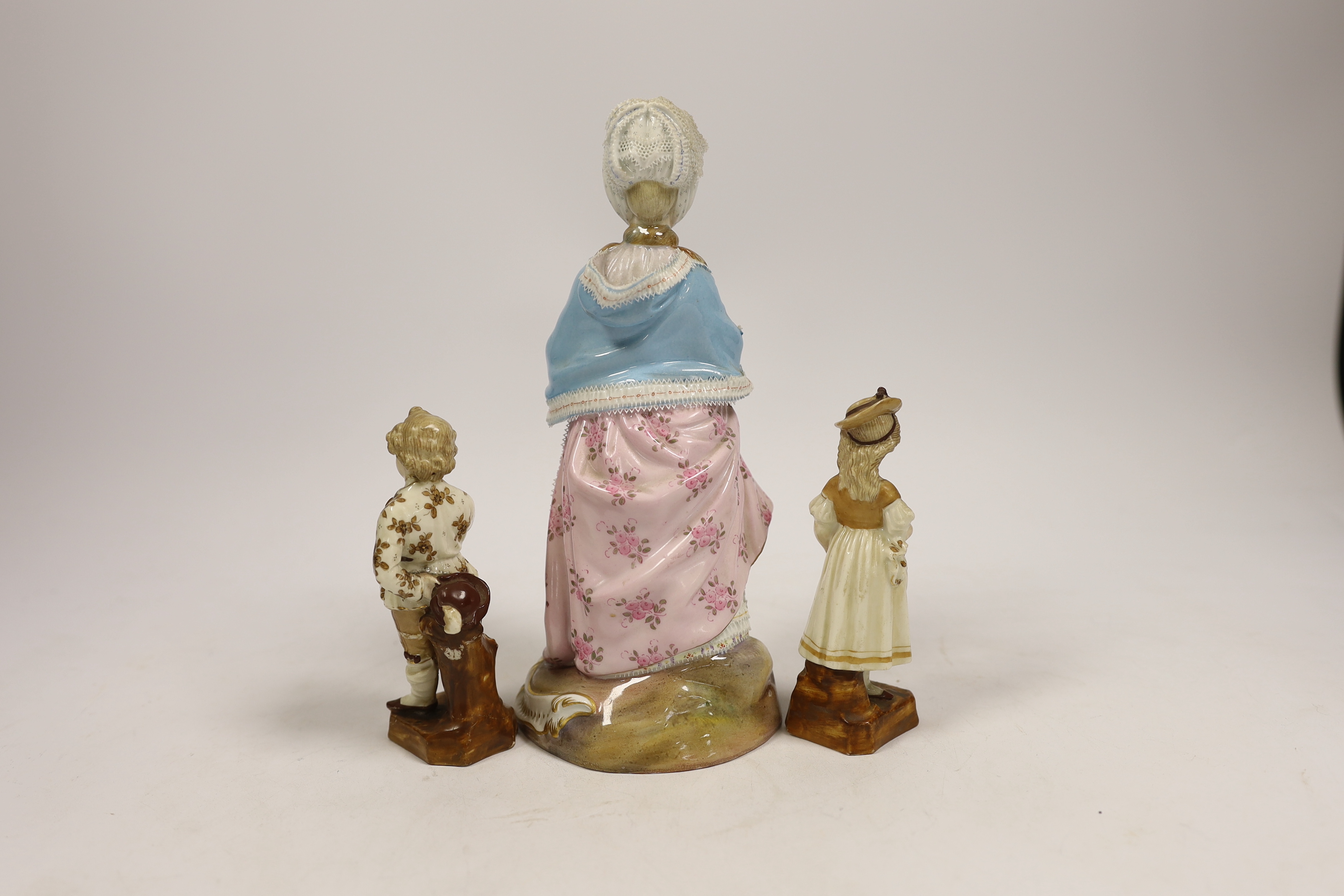 A Meissen figure of a lady, model no D66, 19.5cm, and a pair of smaller German figures